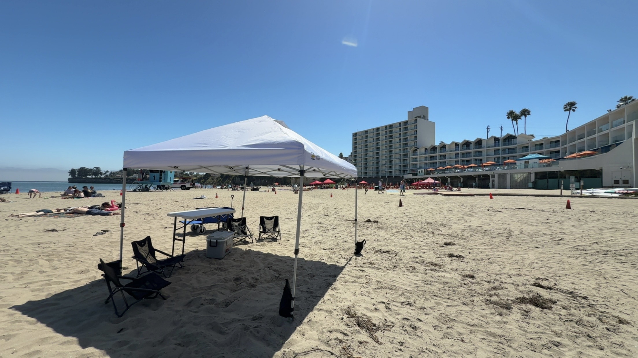Full beach setup with canopy, table, chairs, and cooler