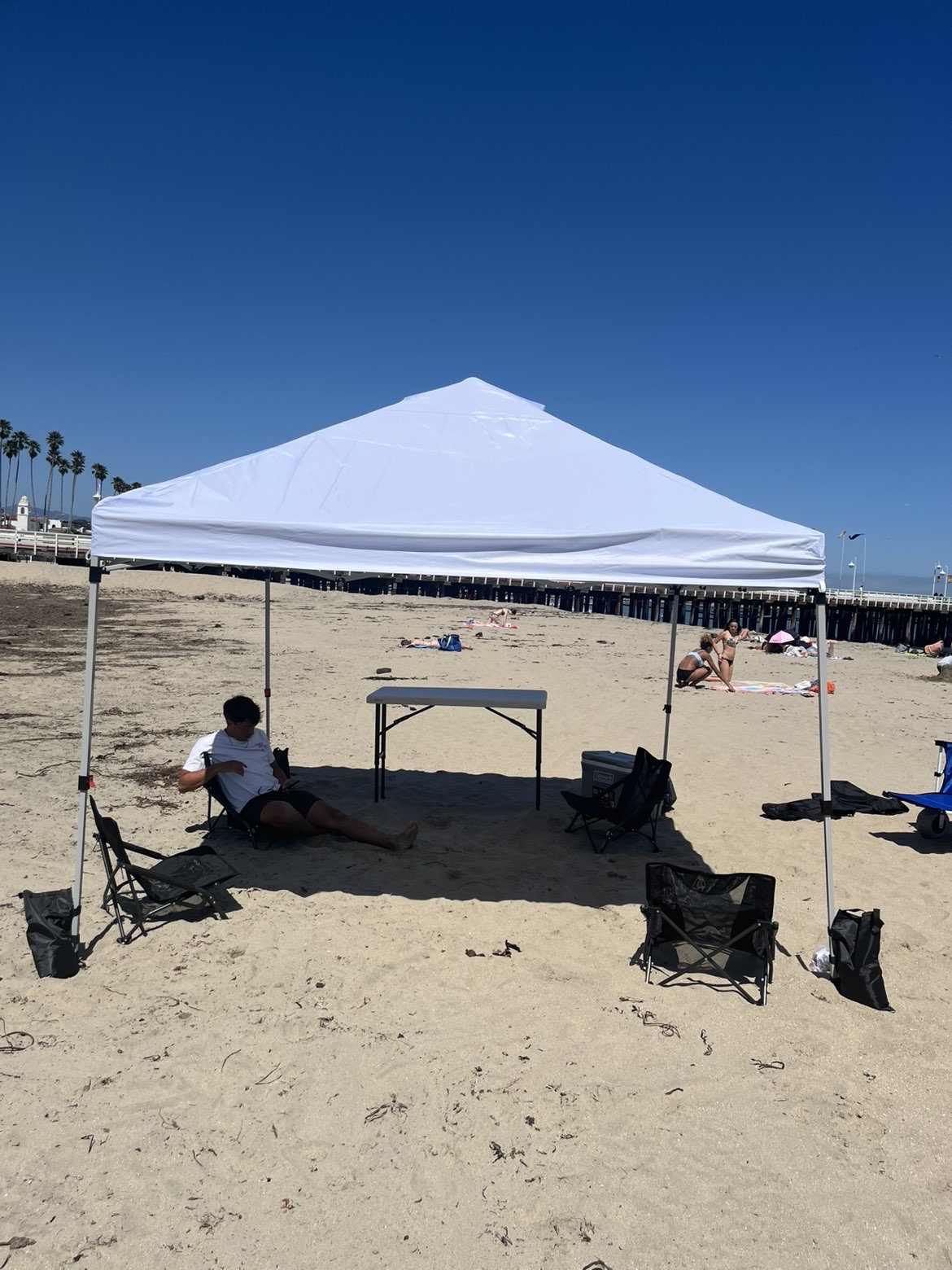 Customer relaxing in the shade of the canopy