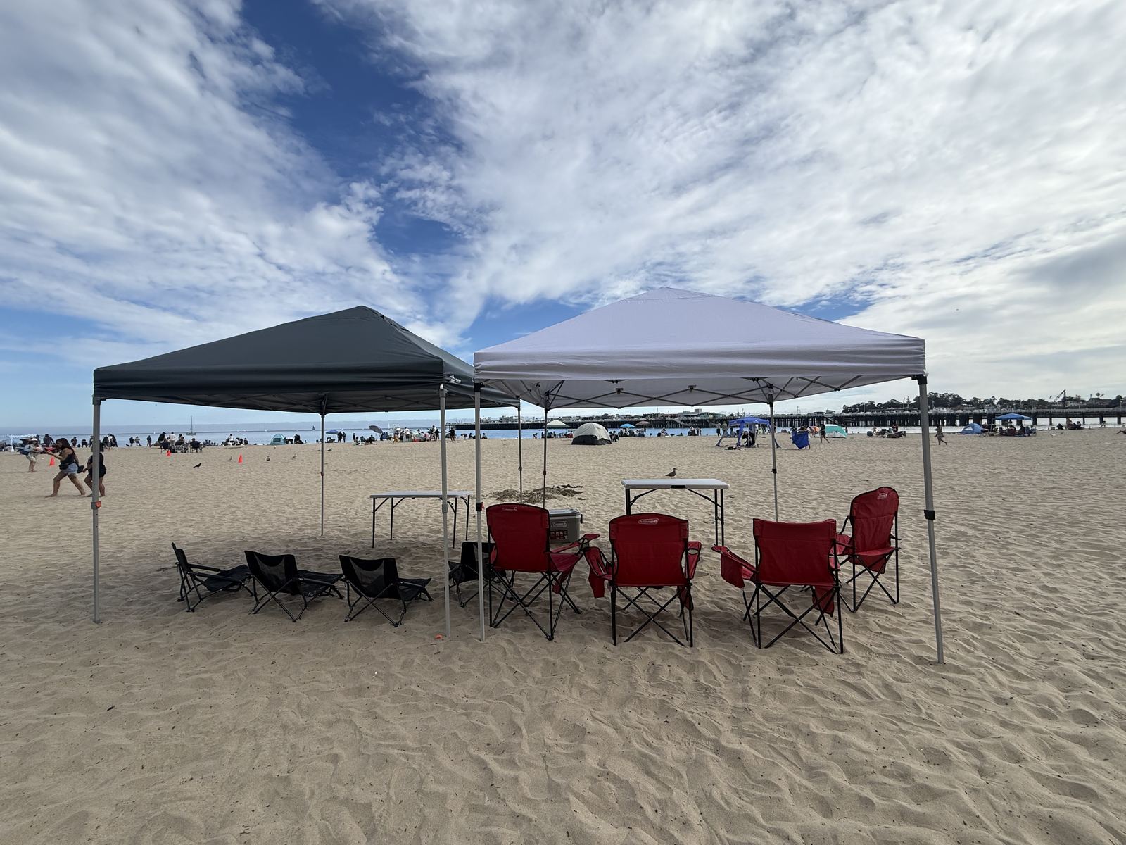 Beachfront cabana setup with Santa Cruz pier in the background